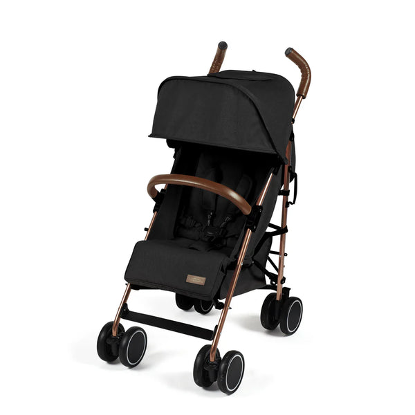 Ickle Bubba Discovery stroller in black with rose gold metallic frame and brown leather-like handles shown from the back side