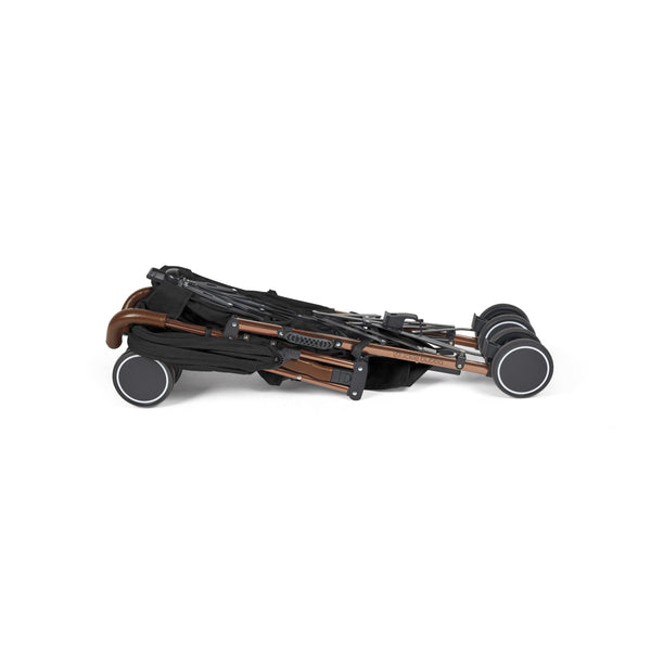 Folded Ickle Bubba Discovery MAX stroller in black with sleek bronze frame and four sturdy wheels