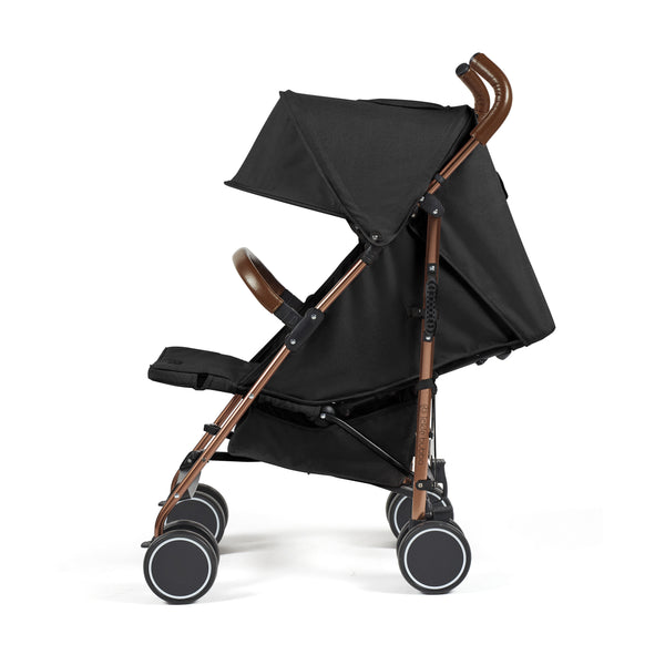 Ickle Bubba Discovery MAX stroller in black with rose gold metal frame and brown leather handles shown from the back side