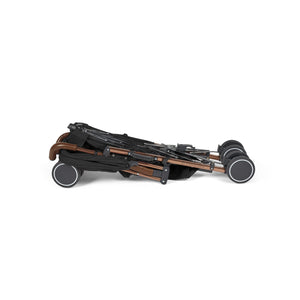 Folded ickle bubba discovery max stroller with sleek bronze frame black fabric and four sturdy wheels