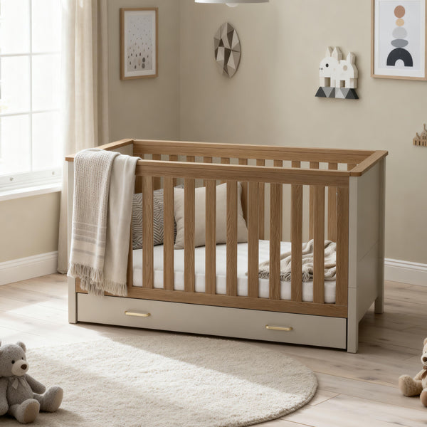 Babymore Mira cot bed in cashmere warm oak with modern wooden light oak slats and beige base with storage drawers