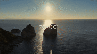 Venicci tila 2 in 1 travel system pram and pushchair with carrycot in noce shown against a venice inspired coastal scene