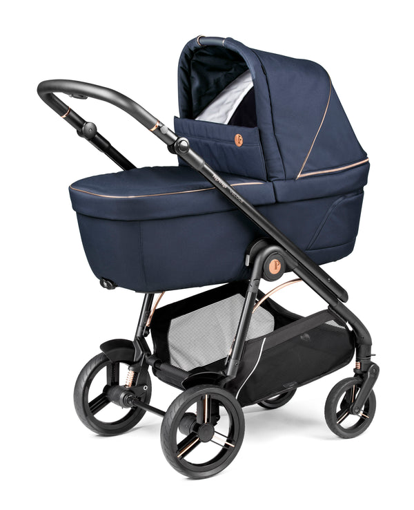 Peg perego veloce deluxe travel system i-size 360 spin bundle in navy blue fabric with black metal frame and rose gold accents