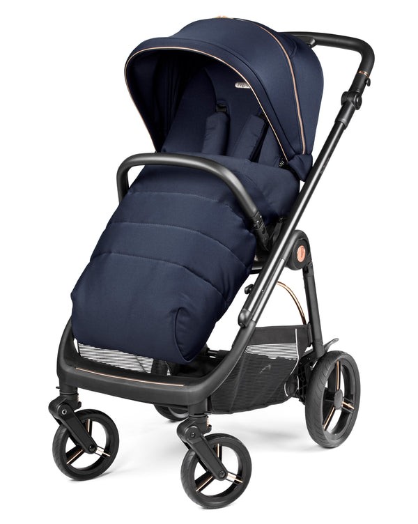 Navy blue insulated stroller with black frame and rose gold accents from peg perego veloce deluxe travel system i-size 360 spin bundle