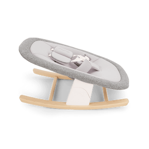 Gray and white fabric Nuna BRYN newborn rocker with wooden rockers for gentle rocking and comfort