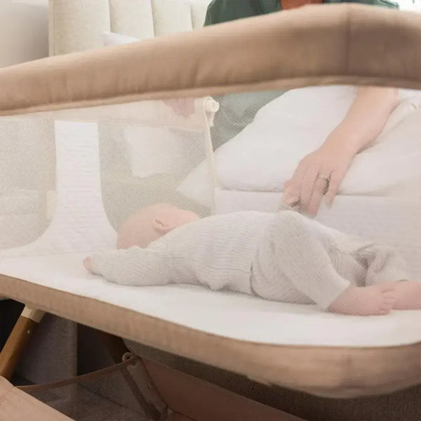 OBaby Cloud Bedside Crib Bundle Including Fitted Sheets – Oatmeal with a baby resting comfortably.