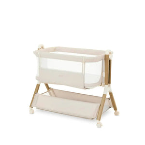 OBaby Cloud Bedside Crib Bundle Including Fitted Sheets – Oatmeal with beige fabric and wooden legs.