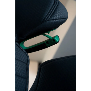 Close-up from below of the green shoulder belt guide beneath the Fresh Black headrest.