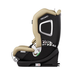Recaro VELIX 1 in Elegant Beige, side view showing silver-trimmed shell, black base and coiled adjustment strap.