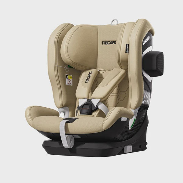 Recaro VELIX 1 in Elegant Beige, angled front view with padded harness, black base and outer side attachment.