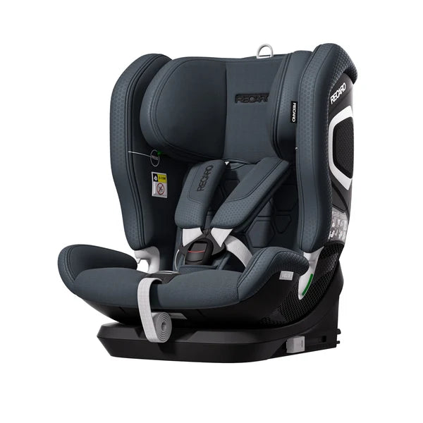 Recaro VELIX 1 in Gallant Grey, angled front view showing padded harness and silver-trimmed side shell.
