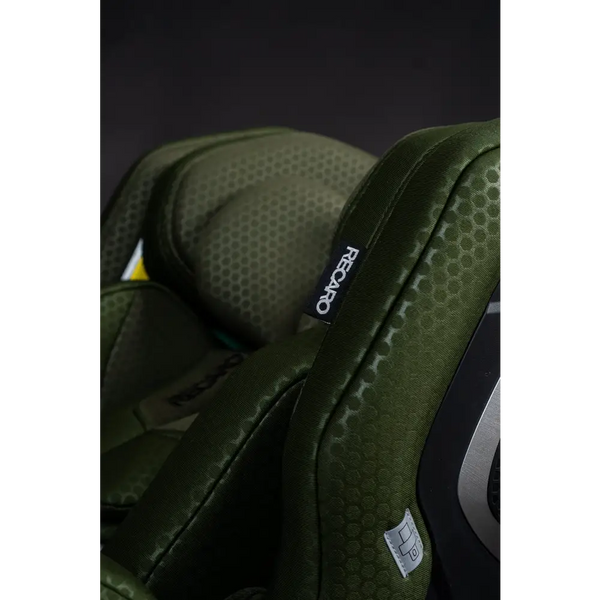 Close-up of the Epic Green XENON 1’s stitched side wing, black Recaro label and grey seat belt symbol label.
