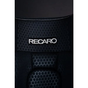 Close-up of the white Recaro logo embroidered on Fresh Black honeycomb-patterned upholstery.