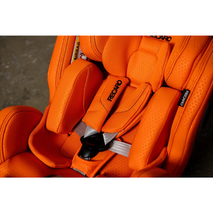 Close-up of the Vibrant Orange XENON 1’s padded insert, shoulder harness, grey straps and central buckle.