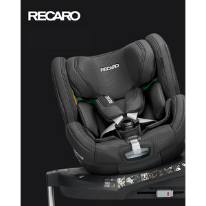 Recaro Fresh Black XENON 1 KID, rotated on its base with padded harness beneath a white Recaro logo.