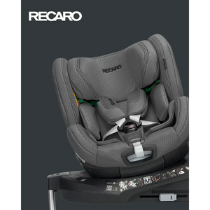 Gallant Grey XENON 1 KID, rotated on its base with padded harness beneath a white Recaro logo.